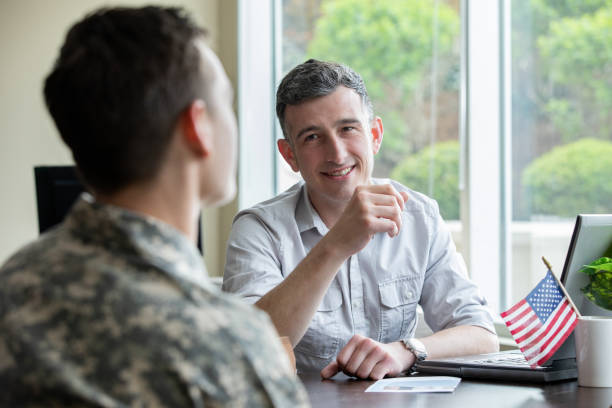 Mature adult man listening while counseling a group of military soldiers